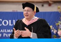 Brian Castrucci speaks wearing a cap and gown